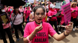 Hundreds of women with brooms join protests as Indonesia leader flies to China